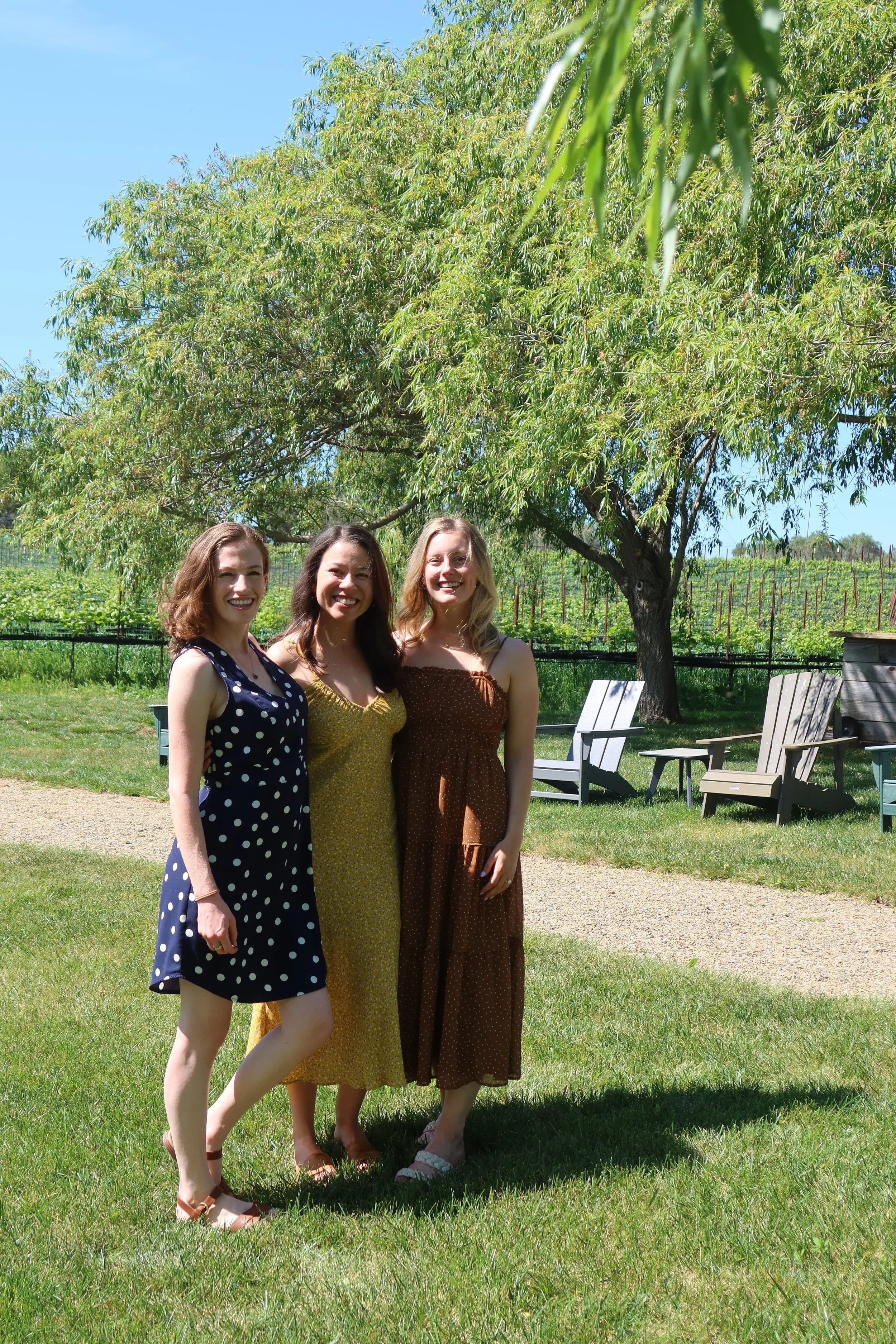 The three founders of Palmetto Psychology Clinic standing together outdoors under a willow tree.